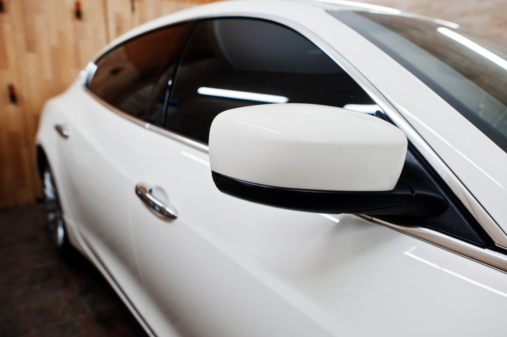 Close-up of tinted luxury car windows showing the sleek style and protective benefits of auto tinting.